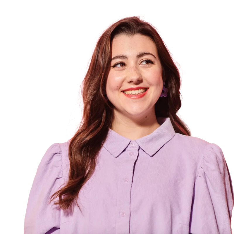 Woman in a pink shirt and long hair smiling
